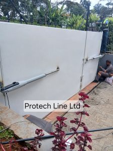 Technician installing Automatic swing gate in Karen Nairobi by Protech Line Ltd