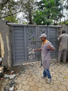 Technician installing an automatic Swing gate motor in Nairobi
