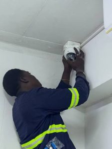 A technician from Protech Line Ltd installing a CCTV camera